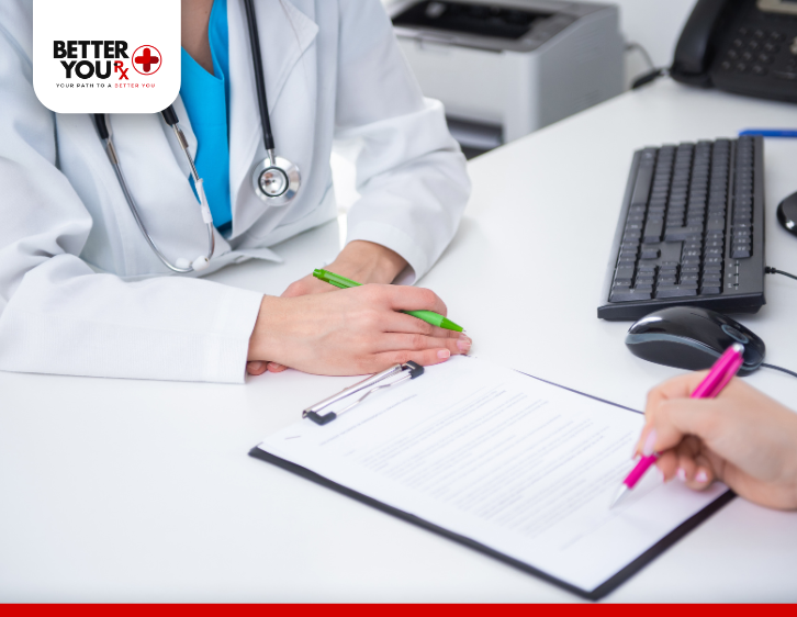 patient signing papers in front of doctor