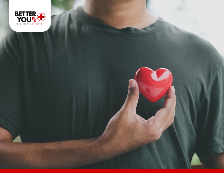 man holding small red heart shape 