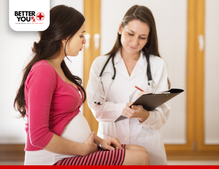 pregnant woman wearing pink doing check up with doctor